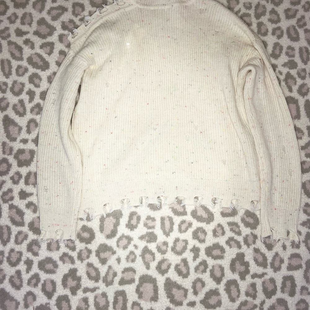 Cream colored spotted ripped sweater